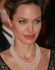Angelina Jolie wearing a three strand pearl necklace
