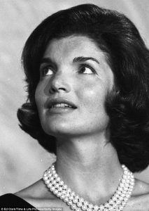 Jackie Kennedy wearing a triple strand pearl necklace