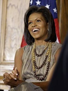 michelle obama wearing a pearl necklace with three strands